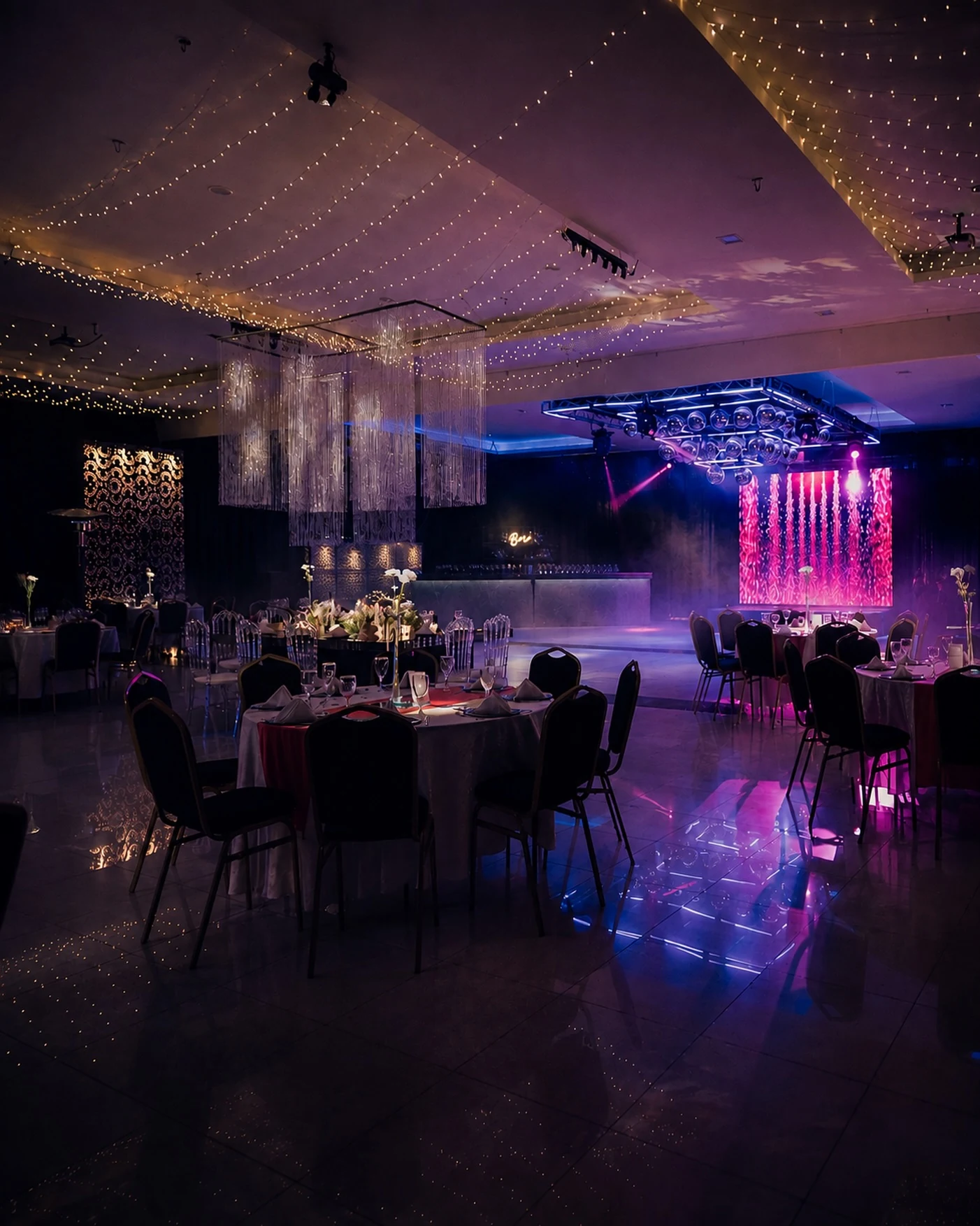 Interior real de La Florentina: mesas preparadas, arañas de luces, pista y escenario iluminado